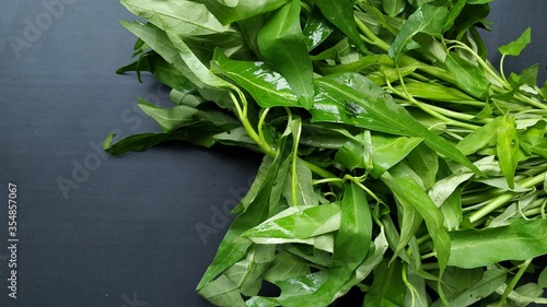 Kale green or kangkung in Indonesia on black isolated background photo