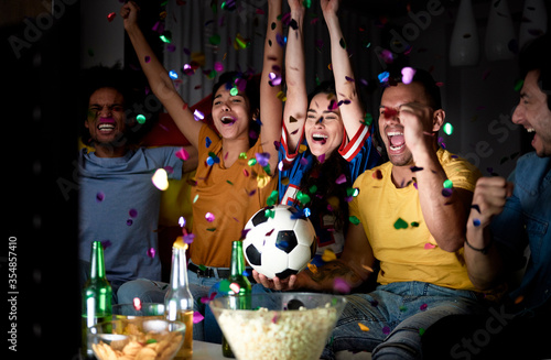 Football fans celebrating victory of their team in the evening photo