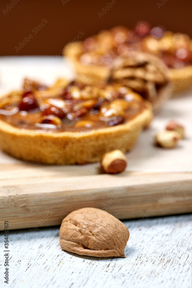 A round cake basket with nuts filled with condensed milk A round cake basket with nuts filled with condensed milk