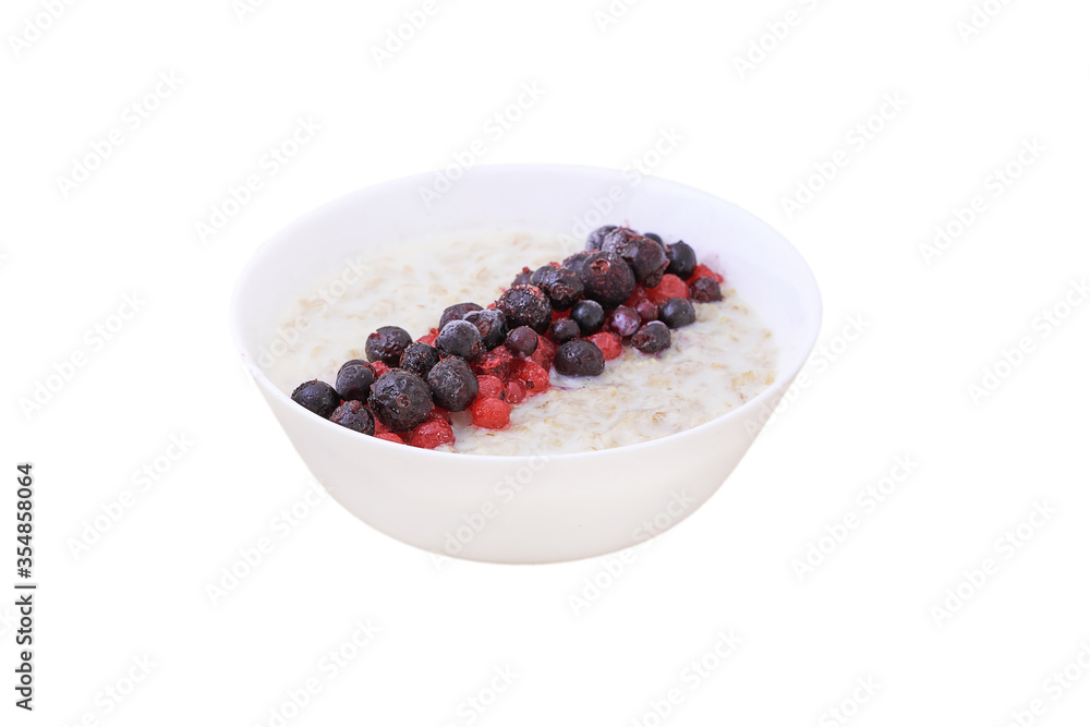Oatmeal in a white bowl of blueberries and red currants. Healthy Breakfast Oatmeal in a white bowl of blueberries and red currants. Healthy Breakfast