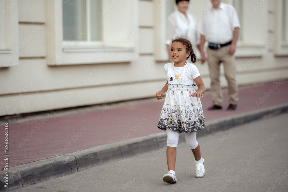 Naklejka premium Grandparents playing with their granddaughter
