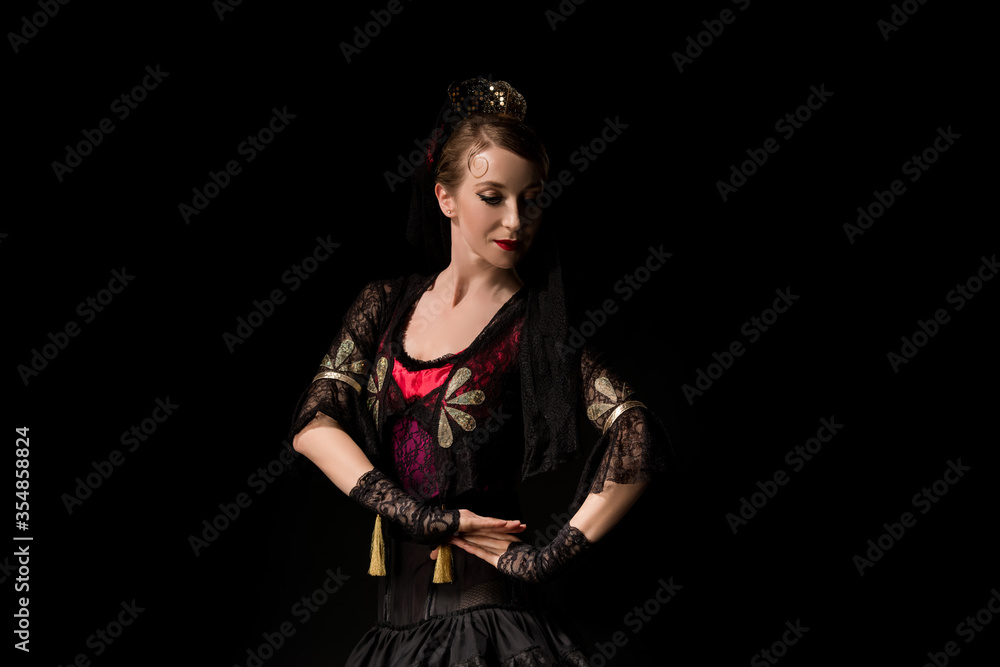 attractive dancer in dress dancing flamenco isolated on black