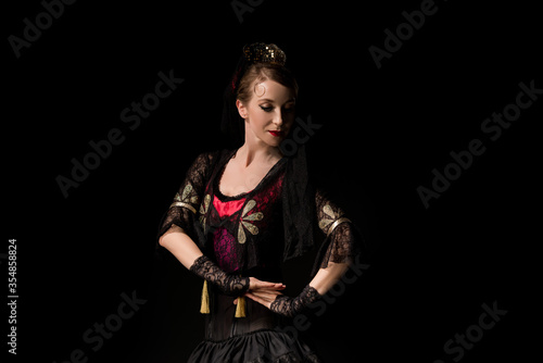 attractive dancer in dress dancing flamenco isolated on black