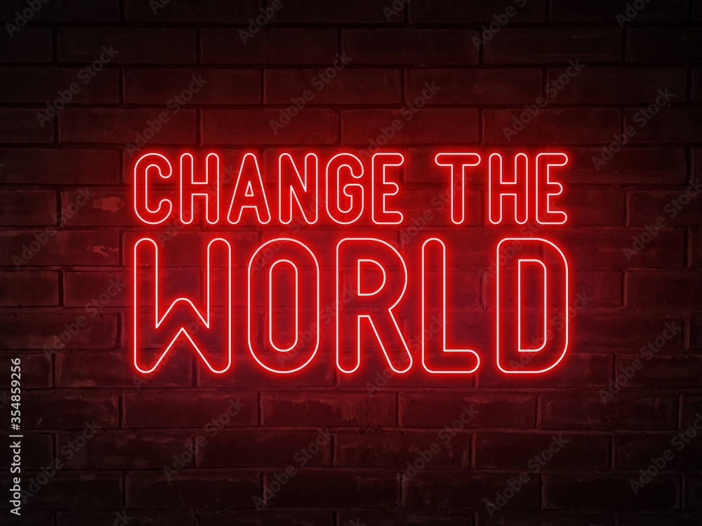 Change the world - red neon light word on brick wall background Change the world - red neon light word on brick wall background