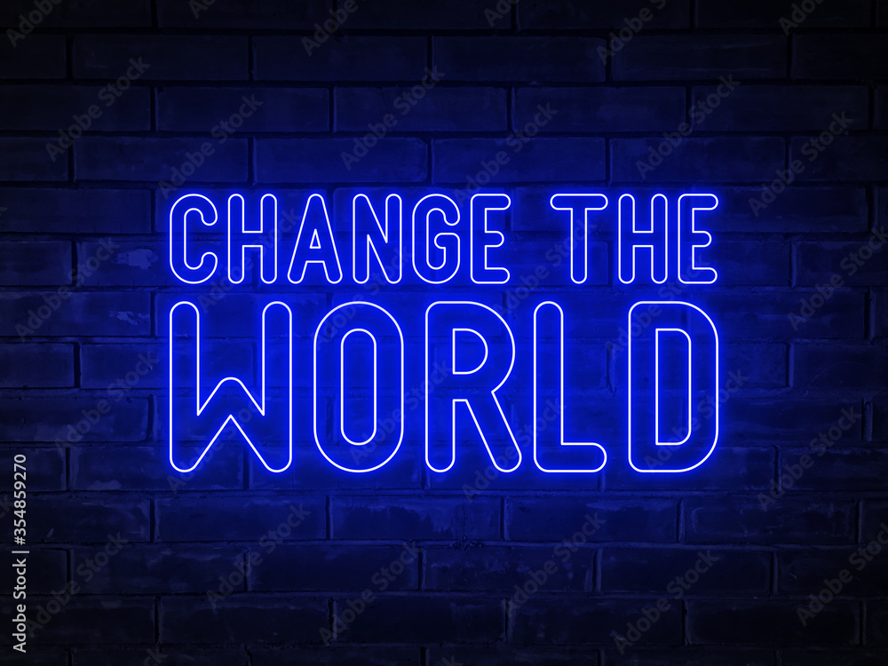 Obraz premium Change the world - blue neon light word on brick wall background