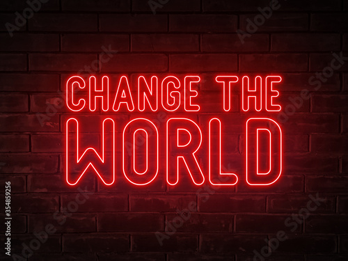 Change the world - red neon light word on brick wall background