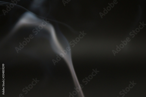 Smoke scented candles on a black background