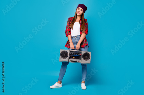 Full length body size view of her she nice attractive pretty lovely cheerful cheery girl carrying tape vintage player isolated over bright vivid shine vibrant blue color background