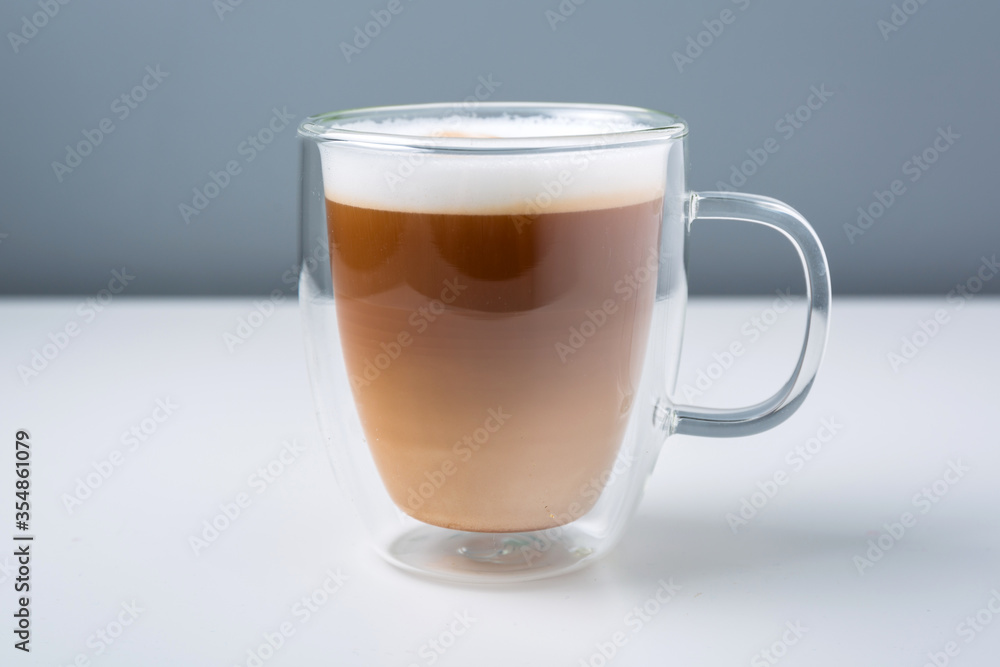 Latte coffee in the glass mug on the table Latte coffee in the glass mug on the table