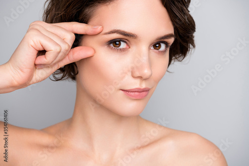 Close up photo of charming pretty gorgeous girl touch finger eyes look in mirror plastic surgery for soft ideal perfect skin effect she tried isolated over gray color background