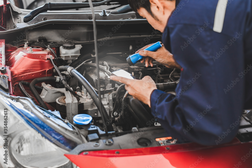 Man mechanic inspection Shine a torch car engine checking bug in engine from application smartphone.Red car for service maintenance insurance with car engine.for transport automobile automotive auto Man mechanic inspection Shine a torch car engine checking bug in engine from application smartphone.Red car for service maintenance insurance with car engine.for transport automobile automotive auto