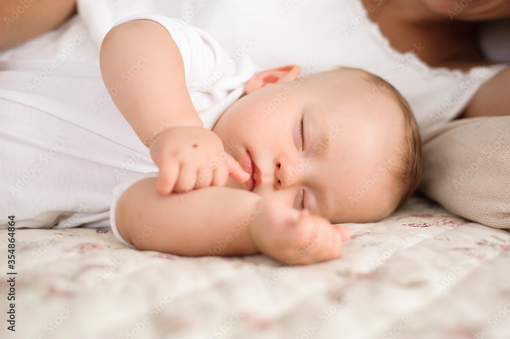 Sweet baby boy sleeping in bed with his mother Sweet baby boy sleeping in bed with his mother