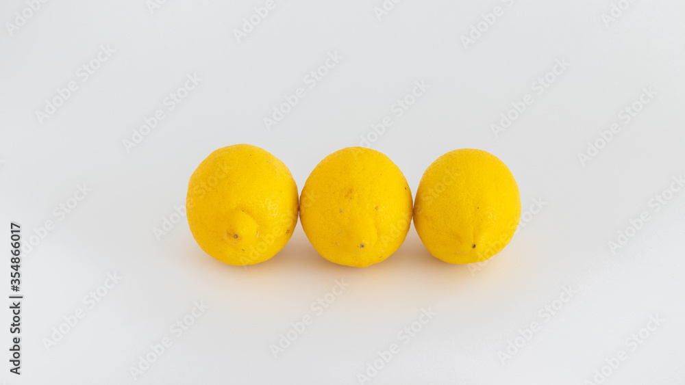 Organic and fresh, yellow lemons on the white background Organic and fresh, yellow lemons on the white background