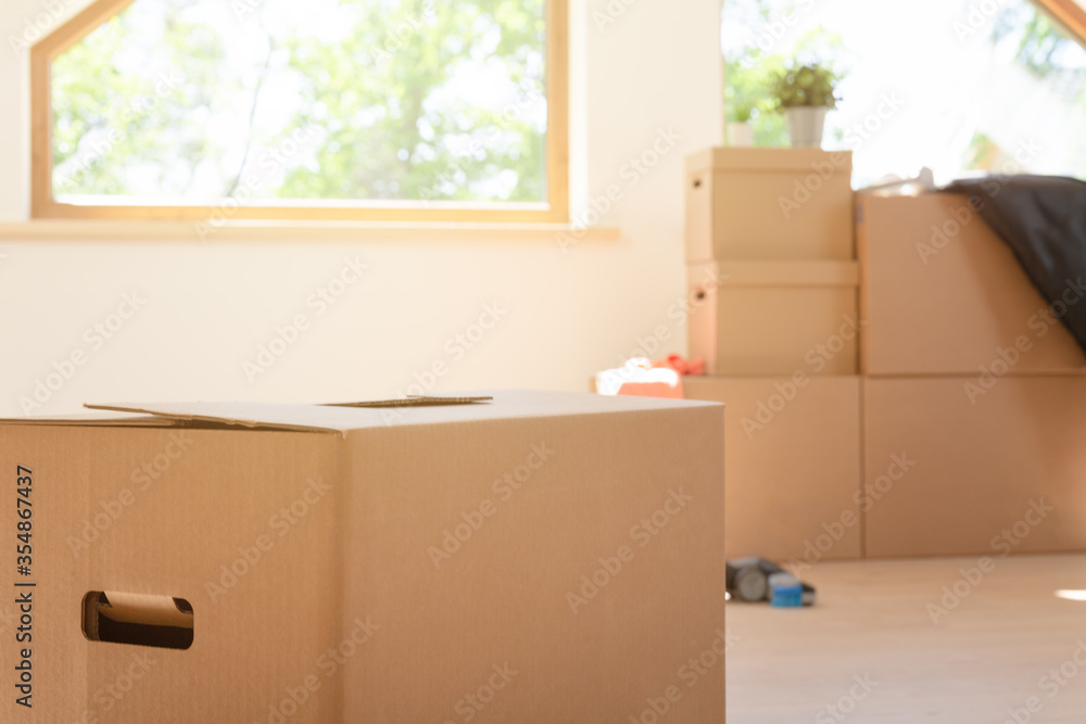 Move. Cardboard boxes for moving into a new, clean home. In a sunny day by a window in attic. Move. Cardboard boxes for moving into a new, clean home. In a sunny day by a window in attic.
