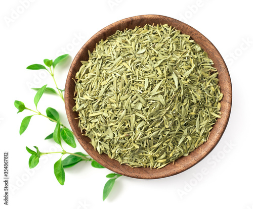 dried thyme leaves in the wooden bowl, with fresh thyme isolated on white background, top view