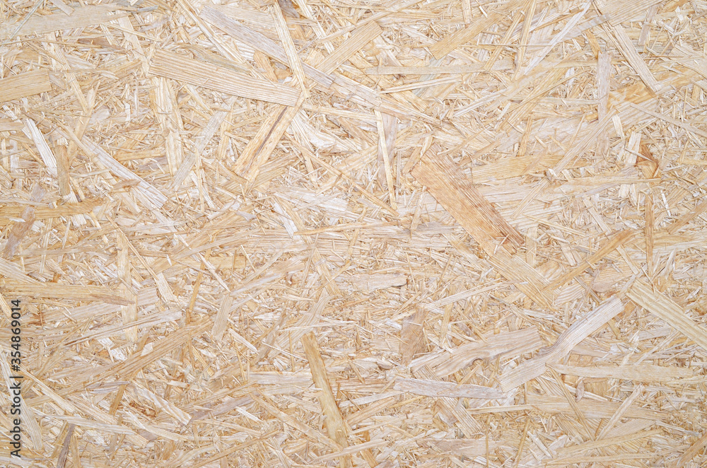 OSB for construction work. Oriented particle board. Wood background. Background from shavings. Wooden texture. OSB for construction work. Oriented particle board. Wood background. Background from shavings. Wooden texture.