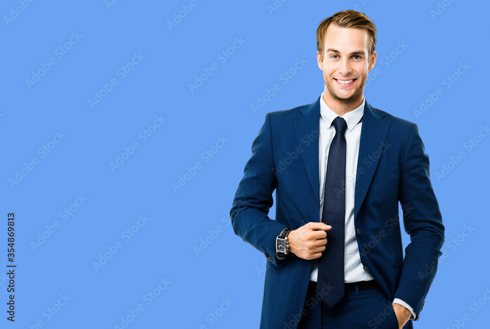 Portrait photo of happy confident businessman in suit and tie, isolated against blue color background. Business success concept. Smiling man at studio picture. Portrait photo of happy confident businessman in suit and tie, isolated against blue color background. Business success concept. Smiling man at studio picture.