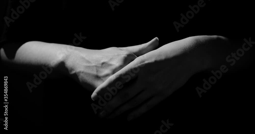 Hands are nervous on a black background, abstraction