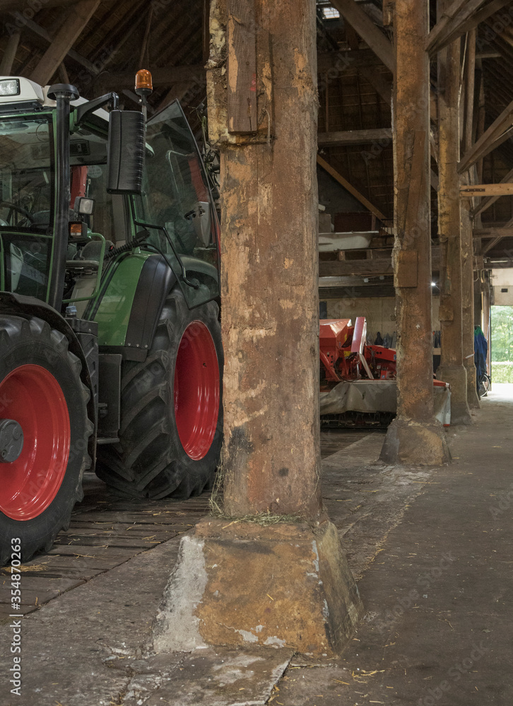 Tractor in old barn. Interiors at Historic farm. Hoeve Marianne Wilhelminaoord. Frederiksoord Drenthe Netherlands. Maatschappij van Weldadigheid Tractor in old barn. Interiors at Historic farm. Hoeve Marianne Wilhelminaoord. Frederiksoord Drenthe Netherlands. Maatschappij van Weldadigheid