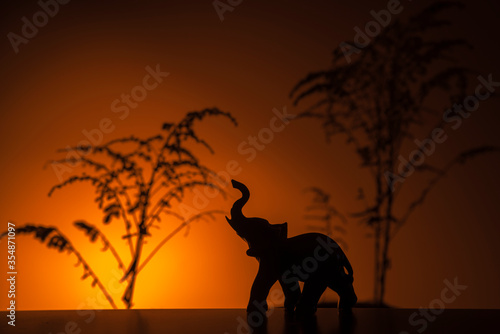 Statue of an elephant on an orange background