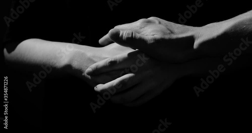 hands are nervous on a black background they are calmed, abstraction