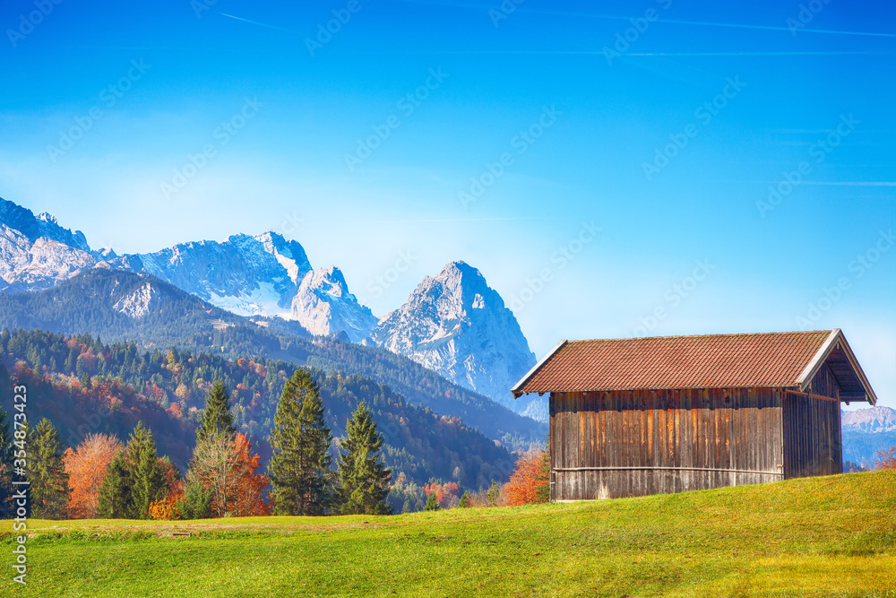 Splendid view of alpine meadow near Wagenbruchsee (Geroldsee) lake with wooden huts
