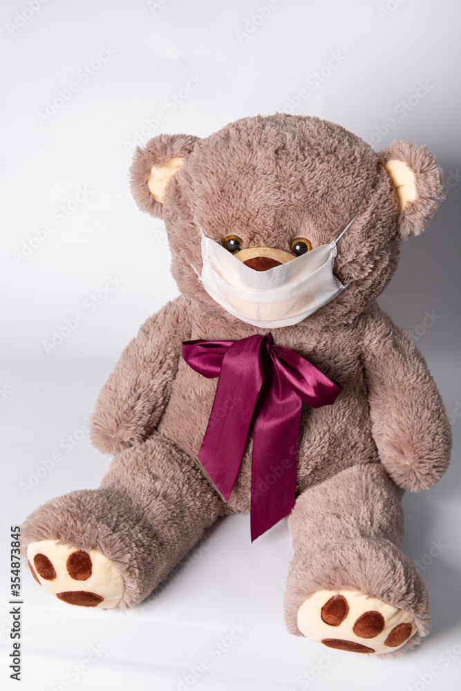 gray toy bear in a medical mask gray toy bear in a medical mask
