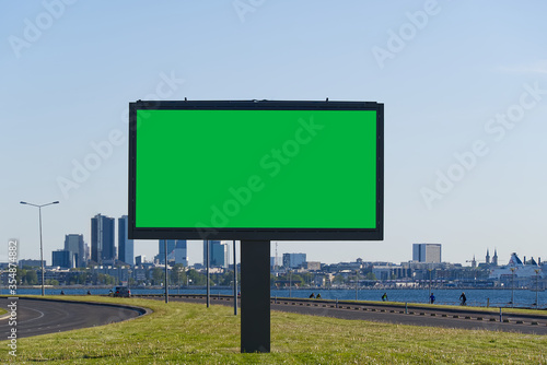 chroma key billboard on a background of cityscape and sea. suitable for advertising. Blank billboard and outdoor advertising. chroma key Mockup poster outside. Tallinn, Estonia.