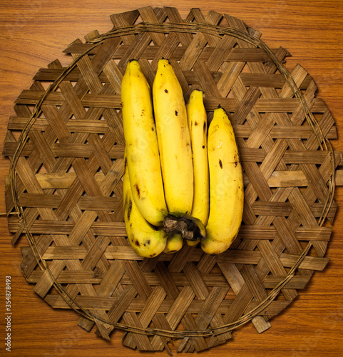 Bananas are placed on a bamboo weave.