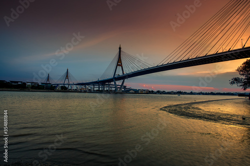 The blurred background of the twilight evening by the river  the natural color changes  the bridge over the river  Bhumibol Bridge  is one of the major transportation bridges in Bangkok  Thailand