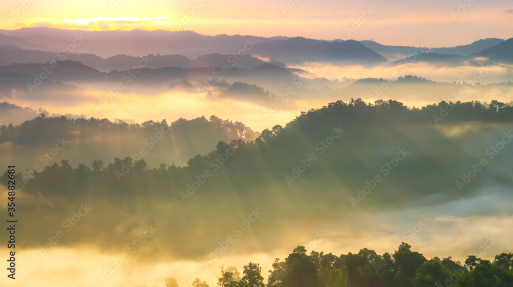 Beautiful Landscape of mountain layer in morning sun ray and winter fog.