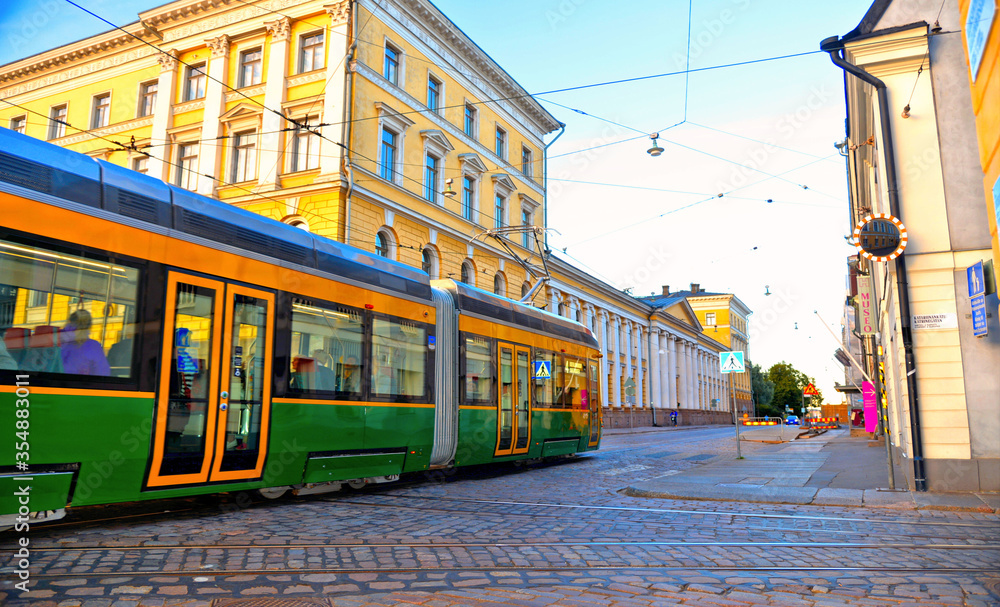 Obraz na płótnie helsinki street with green yellow public tram and big square with old buildings  in background, Finland w salonie