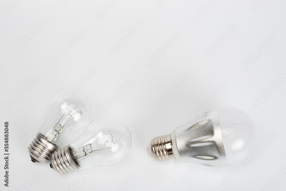 Creativity concept. Shopping cart with light bulb on wooden surface Creativity concept. Shopping cart with light bulb on wooden surface