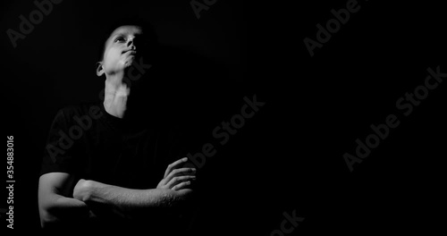 The guy is nervous and rubs his neck. He leaned against the wall. copy space, abstraction