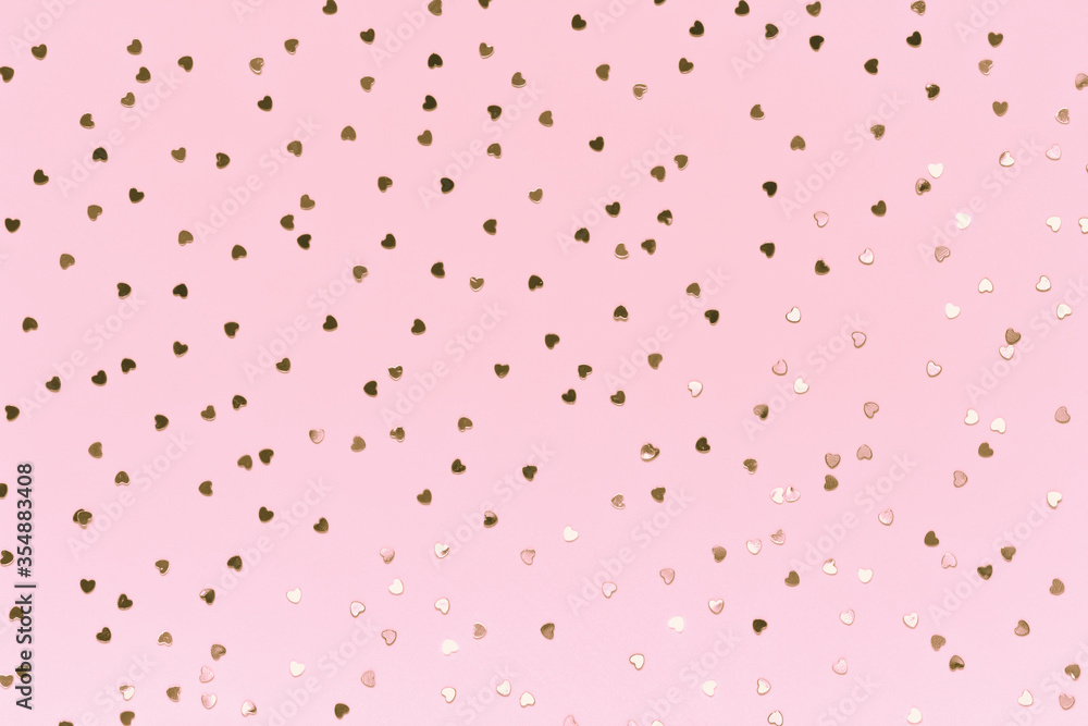 Rose gold heart confetti on pastel pink background