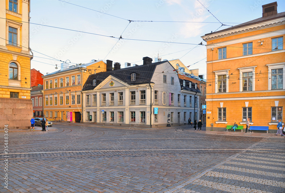 empty street with people, colorful old buildings, architecture and cloudy blue sky in Helsinki, Finland