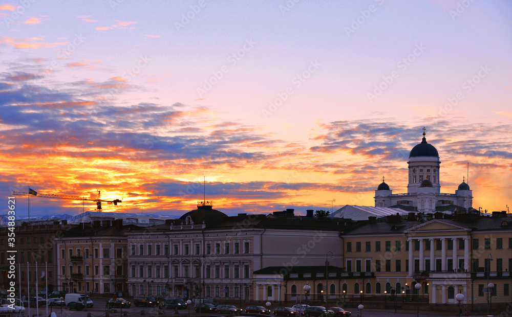  Colorful Panorama Of Embankment In Helsinki with traffic, people and old colorful buildings At Summer Sunset Evening, , Finland. Cityscape View From Sea