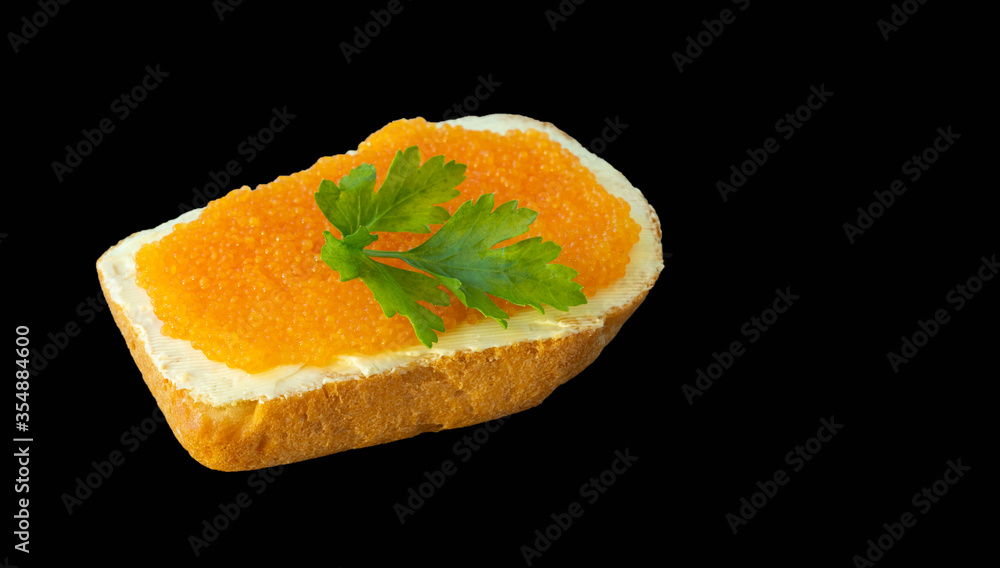 sandwich with red caviar isolated on a black background. sandwich with red caviar isolated on a black background.
