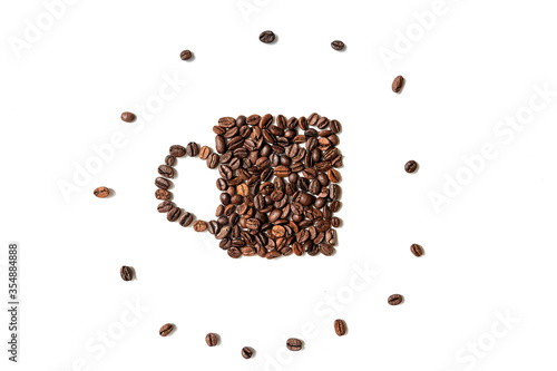 roasted coffee beans in the shape cup on white background. with single coffe beans around. top view. copy space.