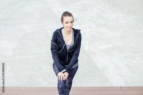 Fit young woman with earpho...