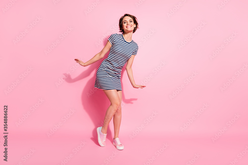 Photo of pretty nice lady skinny shapes good cheerful mood students dancing party wear casual white blue striped summer dress isolated pastel pink color background Photo of pretty nice lady skinny shapes good cheerful mood students dancing party wear casual white blue striped summer dress isolated pastel pink color background
