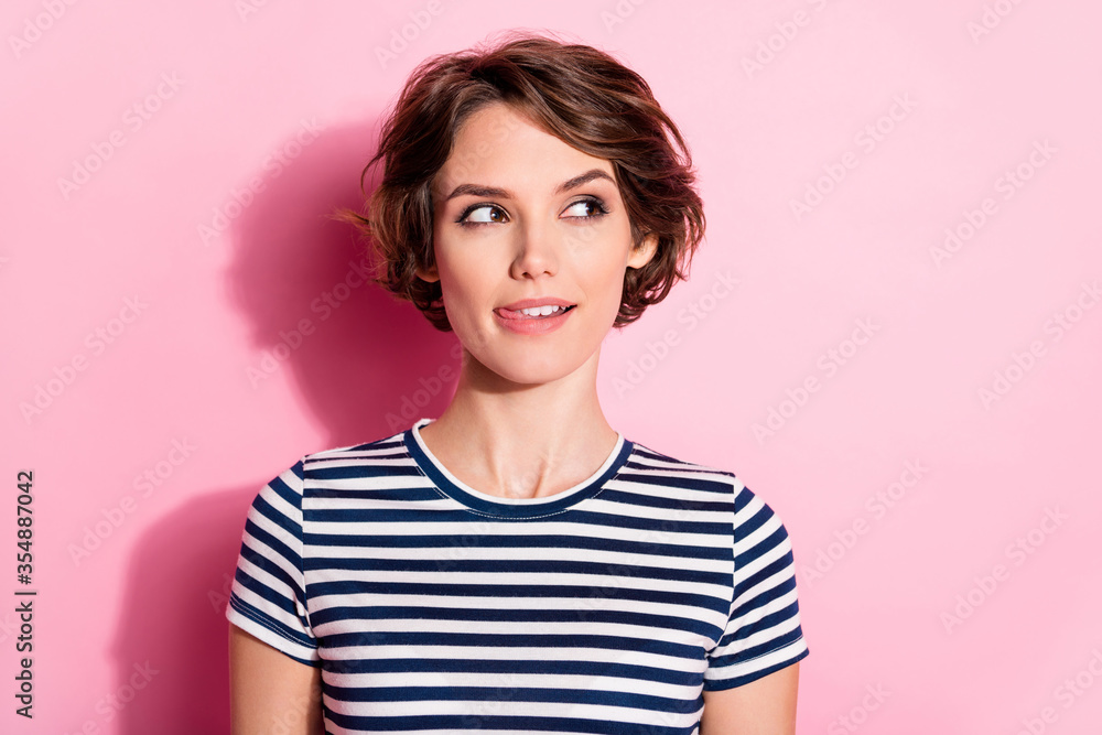 Closeup photo of attractive funny lady short hairdo cunning eyes look side empty space licking lips ready for dinner wear casual white blue t-shirt isolated pastel pink color background Closeup photo of attractive funny lady short hairdo cunning eyes look side empty space licking lips ready for dinner wear casual white blue t-shirt isolated pastel pink color background