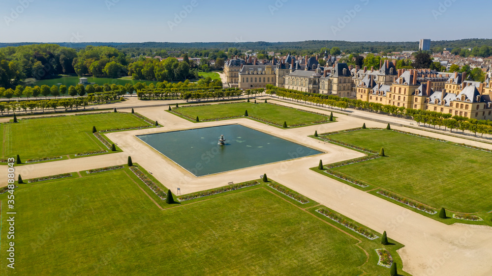 Aerial view of medieval landmark royal hunting castle Fontainbleau near Paris in France and lake with white swans Aerial view of medieval landmark royal hunting castle Fontainbleau near Paris in France and lake with white swans
