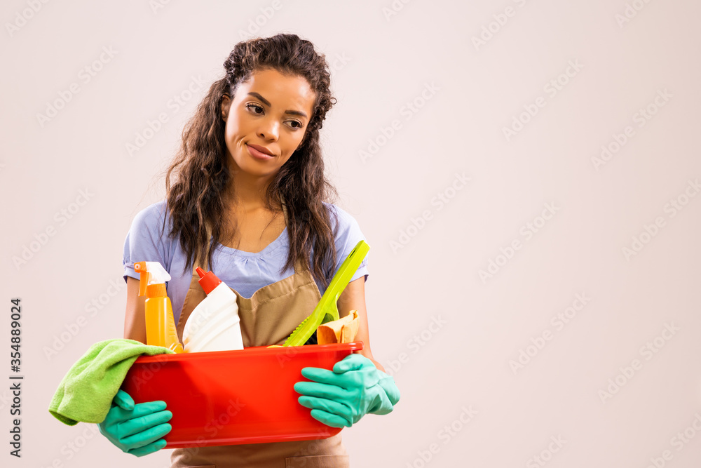 Portrait of african-american professional maid who is tired of cleaning. Portrait of african-american professional maid who is tired of cleaning.