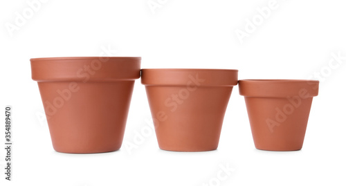 Stylish terracotta flower pots isolated on white