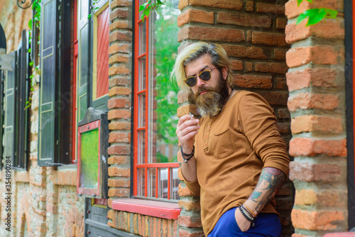 Smoking man. Sensual bearded man with cigarette. Cigarette. Bearded man smoke the cigarette. Sensual man smoking outside. Tobacco. Stylish hipster with cigarette.