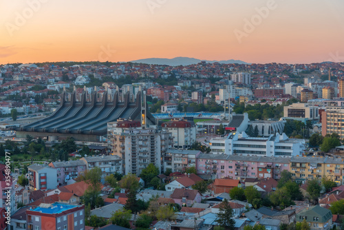 Sunset view fo landscape of Prishtina with Palace of Youth and Sports in Kosovo photo