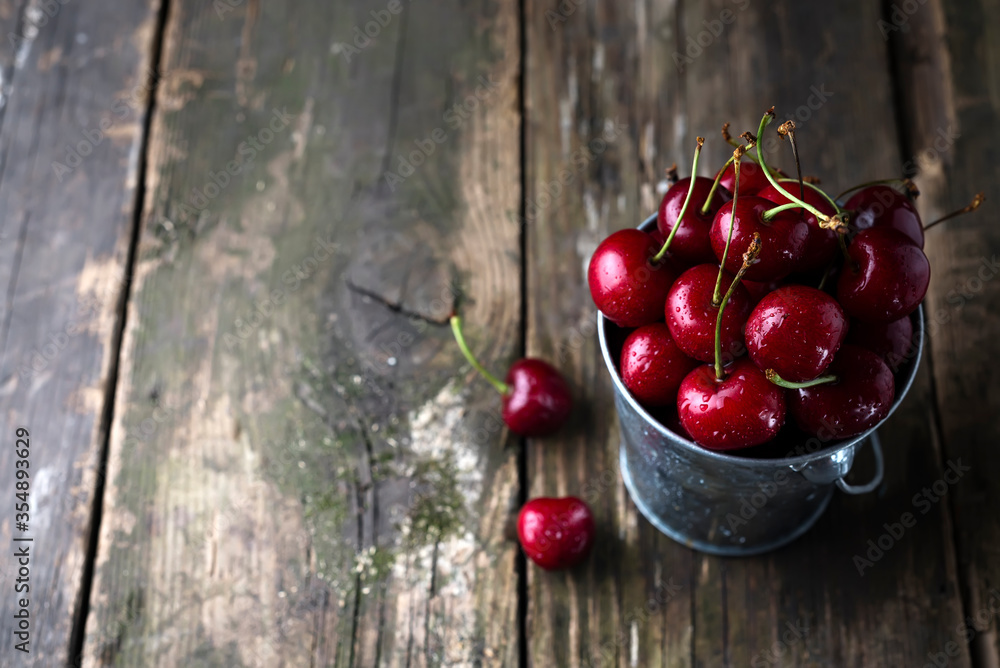 Fresh red Cherries on wooden table with water drops Fresh red Cherries on wooden table with water drops