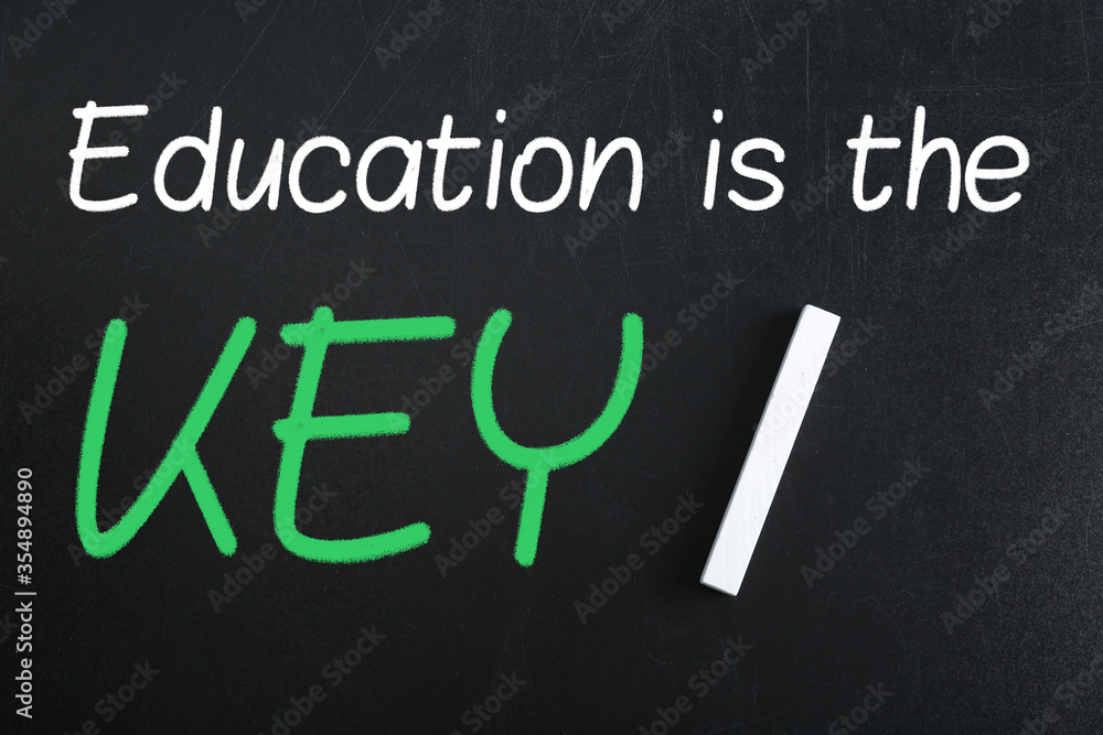 Obraz premium Piece of white chalk and phrase Education is the KEY on blackboard, flat lay. Adult learning
