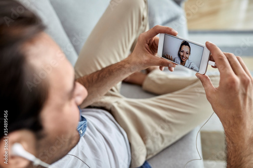 Close-up of a man making video call over smart phone with his girlfriend.